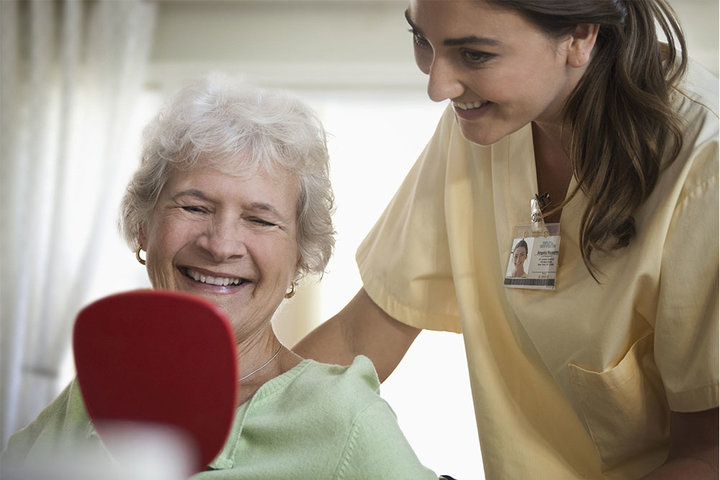 Occupational Therapist Assisting Elderly Woman with Daily Hygiene Routine