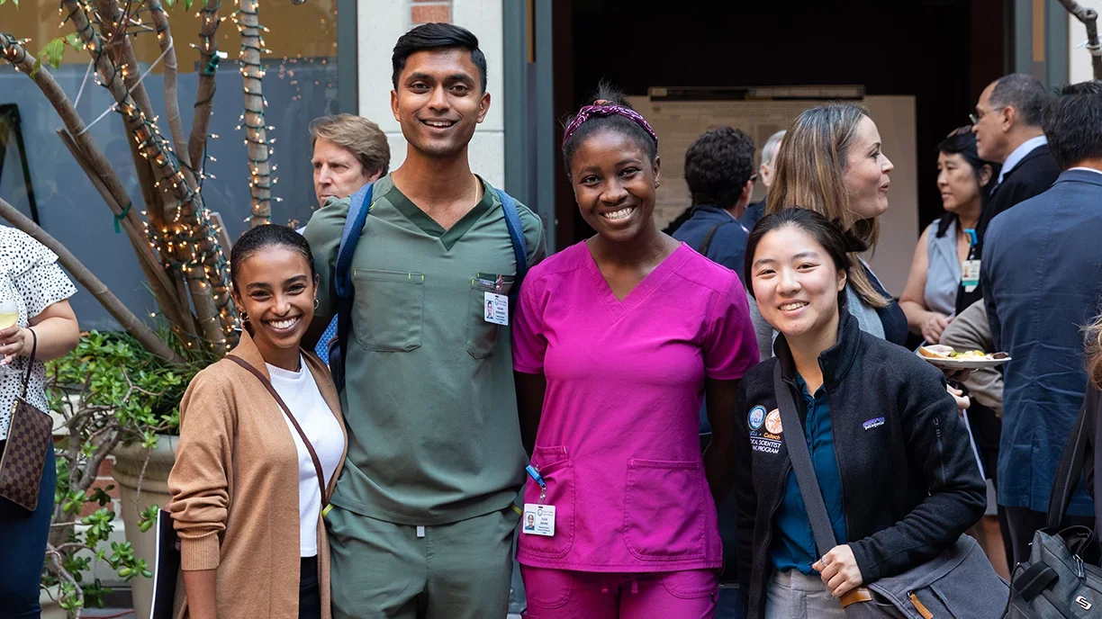 Four residents pose for a group photo at the STAR symposium