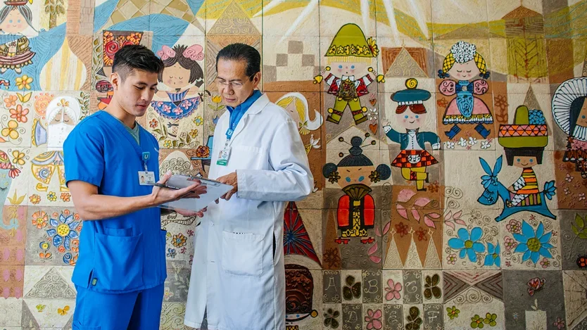 A trainee and a mentor conferring near the UCLA Mattel Children's Hospital
