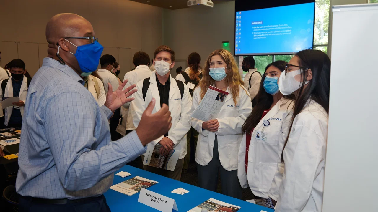 Admissions staff talking to students about pre-med & pre-health programs
