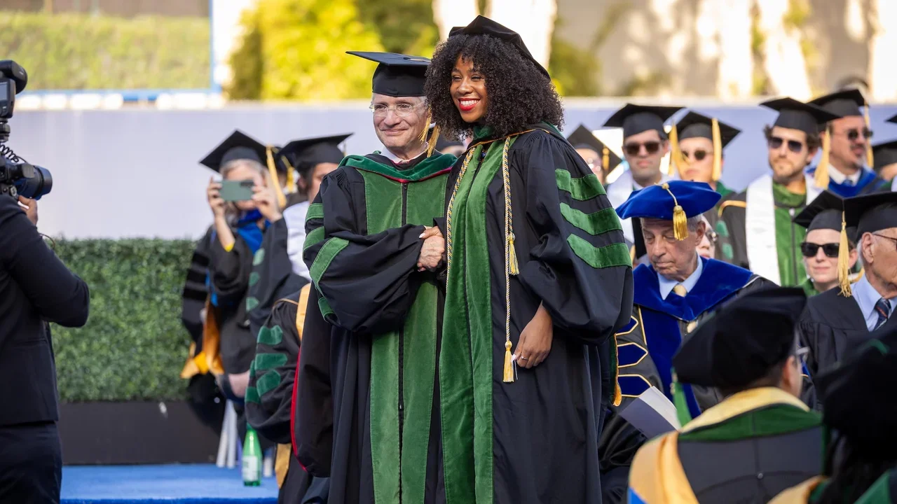 The Dean shaking hands with a student at commencement