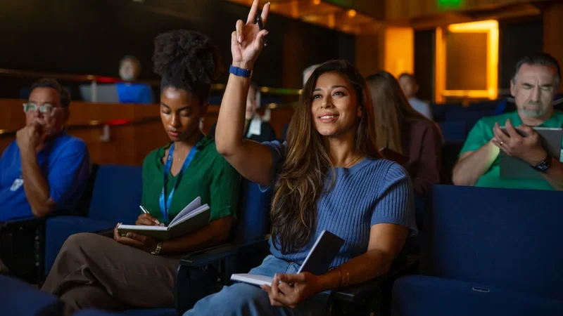 Medical student raising hand in classroom