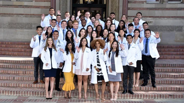 Medical students on the stairs of an academic building