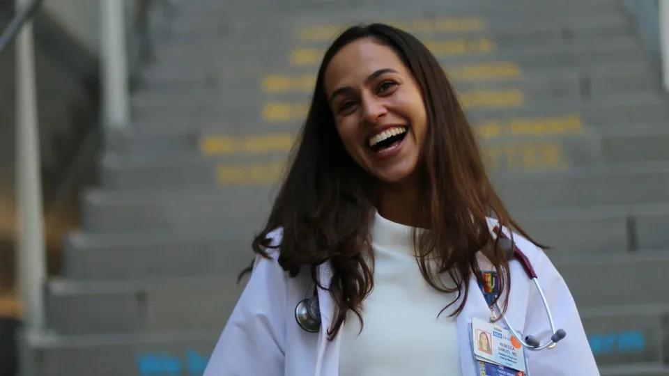 A DGSOM resident on Geffen Hall stairs