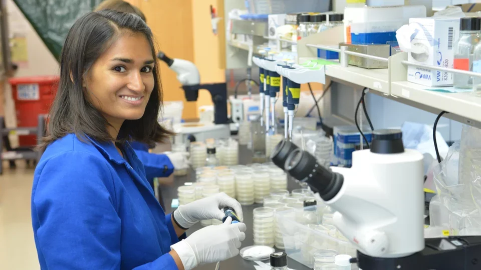 A research trainee smiles at the bench.
