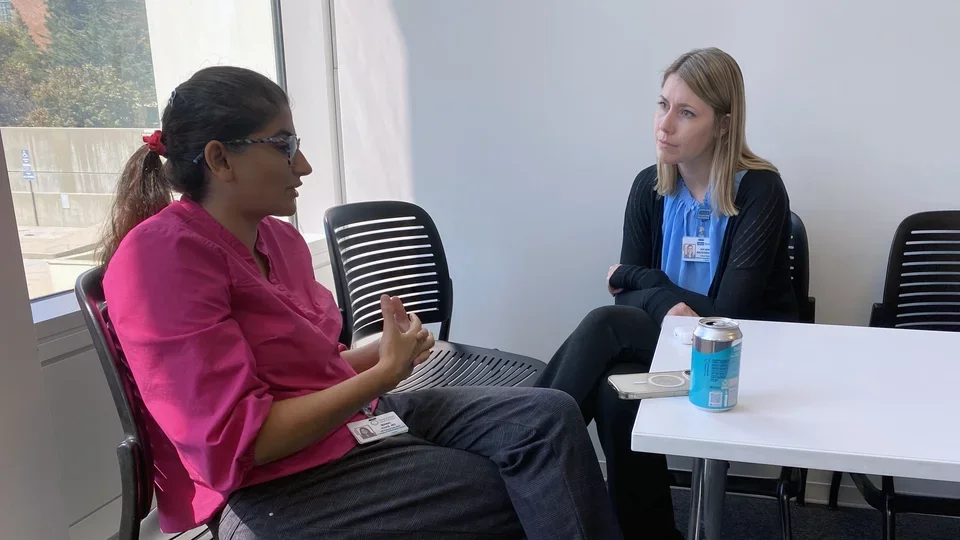 Two female fellows discussing
