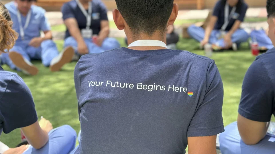 Students huddled in a circle participating in an activity. 