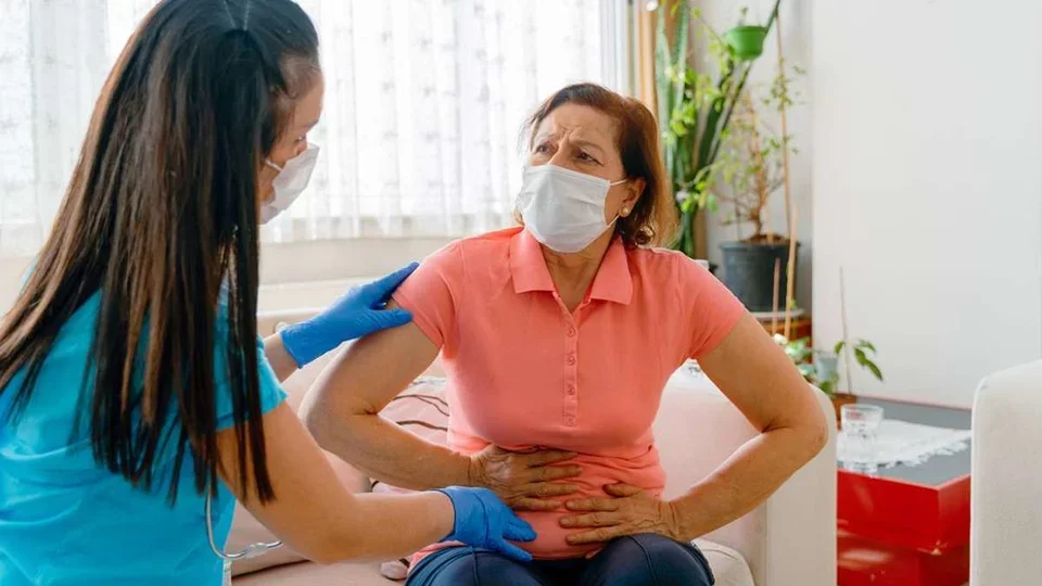 Symptoms of IBS Woman Patient Clutching Stomach in Pain