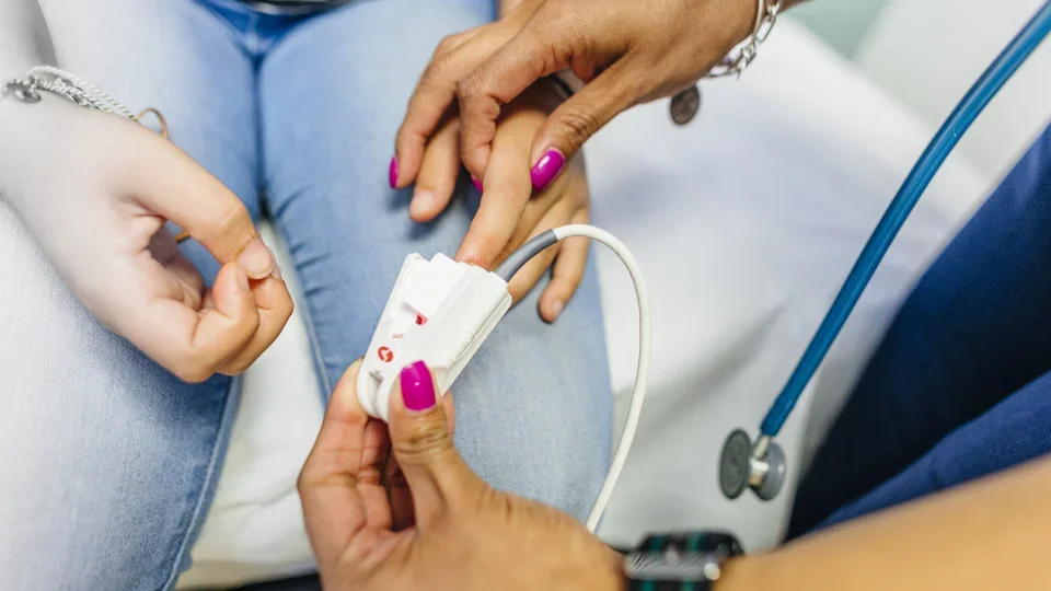 What Is a Cardiologist? Cardiologist taking a patient's pulse