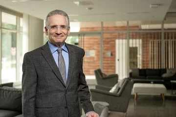 Dean Dubinet standing in office