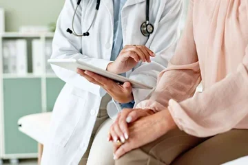 A physician communicating advanced care options with a patient 