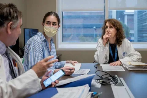 Dr. Terri Getzug and Dr. Wayne Grody, discussing a Familial Mediterranean Fever case 