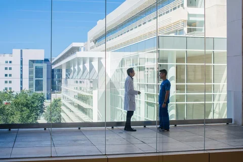 Resident speaking with faculty member