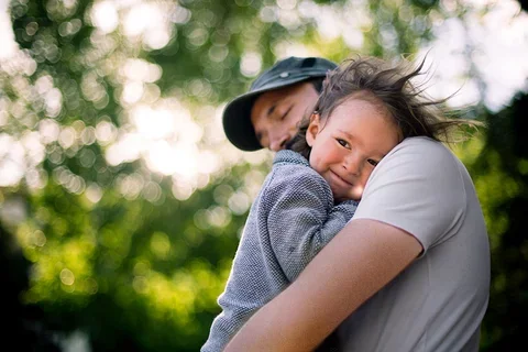 Caring for Autism Patients Man Holding Child