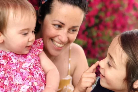 mother and daughters laughing