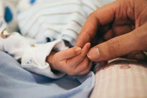 Parent and baby closeup of hands
