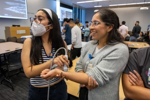 Medical students using equipment at POCUS intro course