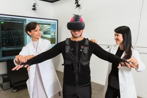 Investigators researching virtual reality technology with a human subject