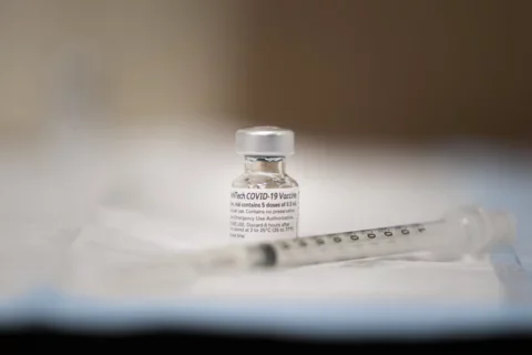 COVID-19 vaccine vial and needle