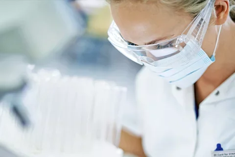 An infectious disease doctor wearing a face mask and goggles