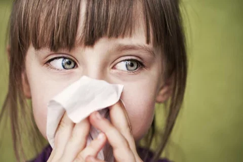 woman blowing nose