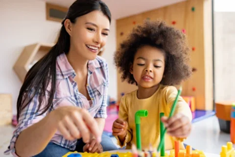 teacher and kid playing