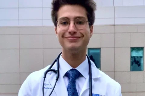 Medical student Eric Smith, pictured wearing his white coat, shares his story of becoming a doctor