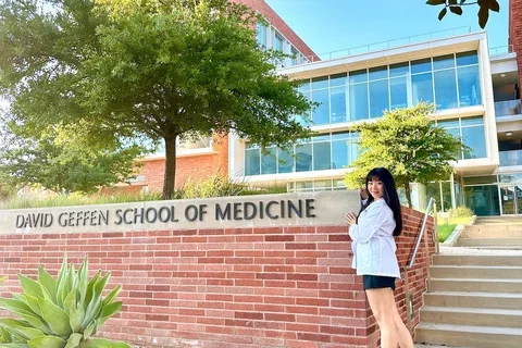 Medical student Joy Xu, pictured in front of the DGSOM sign, shares her story of becoming a doctor. 