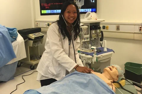 Medical student Melanie Ramirez smiles during a clinical training exercise 