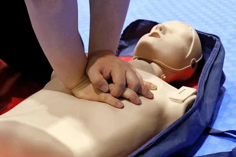 Man performing CPR on a mannequin.