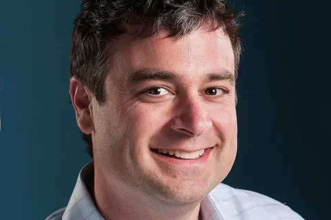 Man's face and shoulders smiling