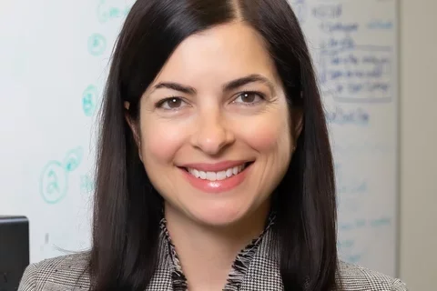 woman in grey suit in office