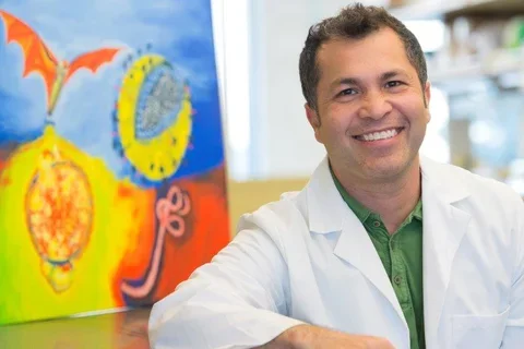physician in lab coat sitting in office
