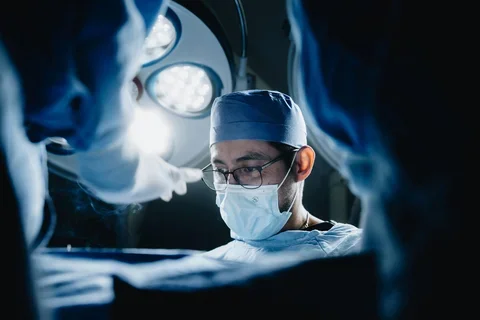 Surgeon performing operation in modern hospital