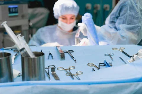 surgical equipment and woman performing surgery