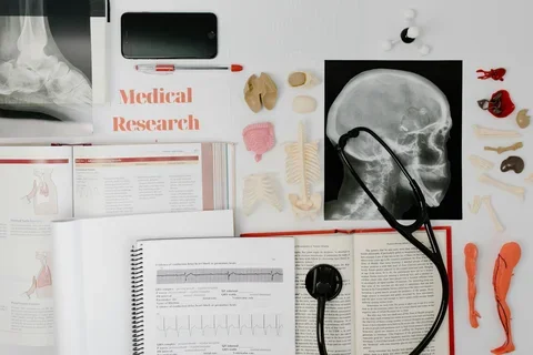 books and x-ray of a skull on a table
