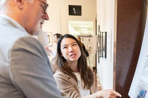 Woman pointing at poster presentation