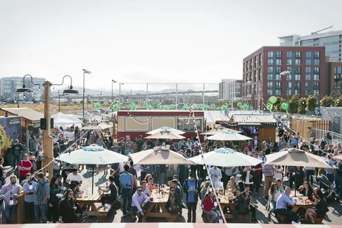 Overhead photo of people socializing umbrellas at a party