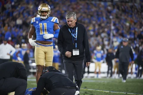 Sports medicine physician helping a UCLA football player 