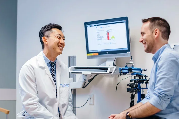 A doctor and a patient smiling in a medical office