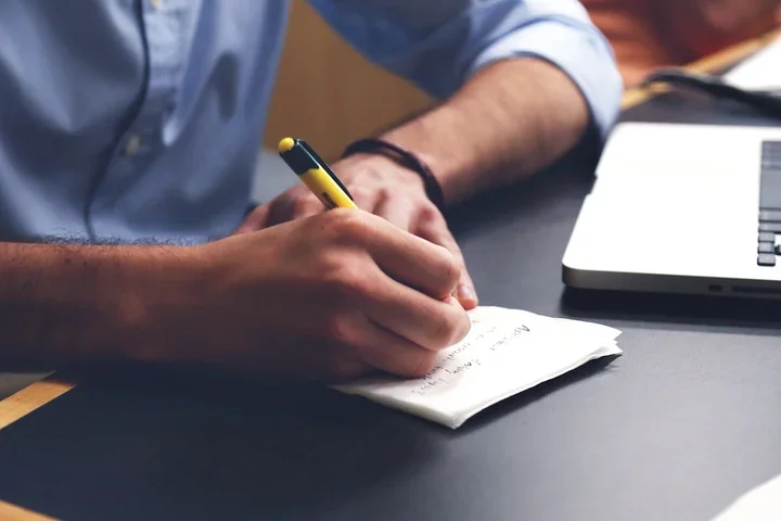 A person writing by hand