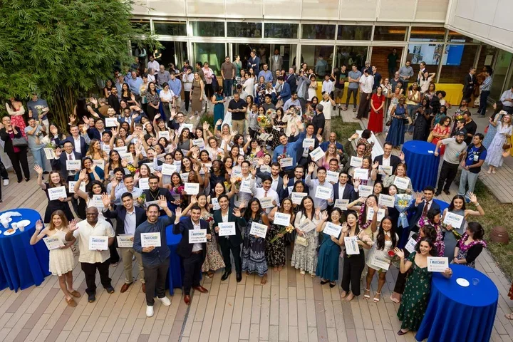 The David Geffen School of Medicine at UCLA class of 2026 holds up their Match Day cards at Geffen Hall at UCLA