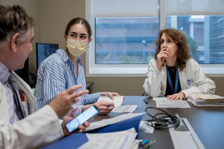 Dr. Terri Getzug and Dr. Wayne Grody, discussing a Familial Mediterranean Fever case 