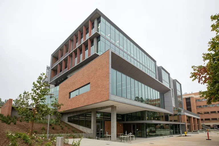 UCR SOM Building with red brick on one side and glass on another side.