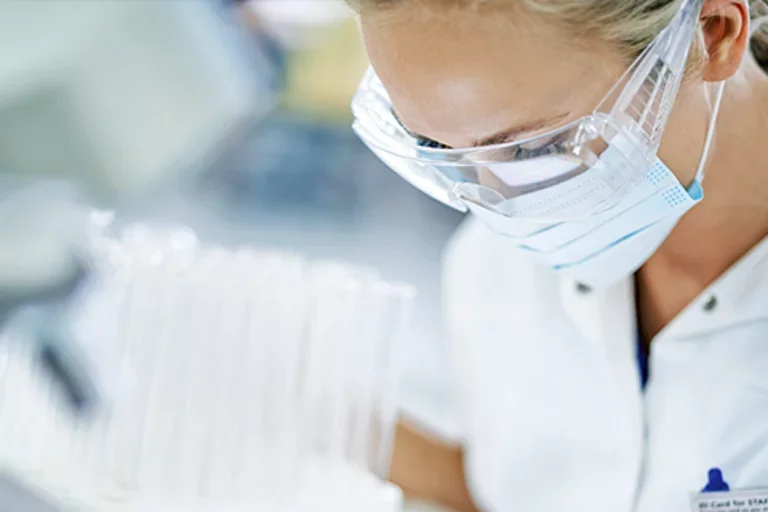 An infectious disease doctor wearing a face mask and goggles 