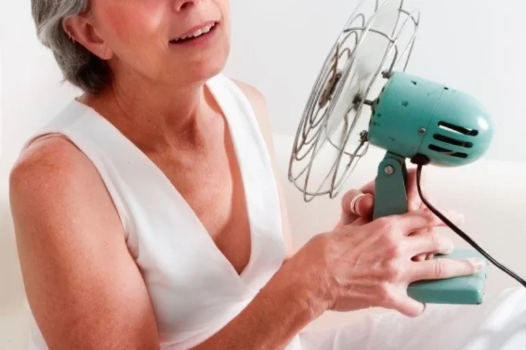 Woman with fan blowing