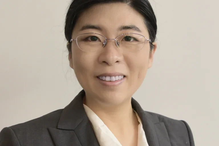 Headshot of Dr. Shuibing Chen in a gray suit with glasses. 