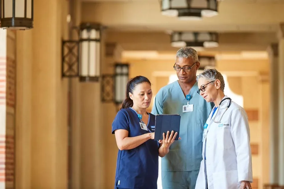 A care team discussing in the hallway of UCLA Santa Monica Medical Center.