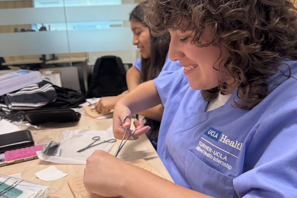 Medical students practice suturing