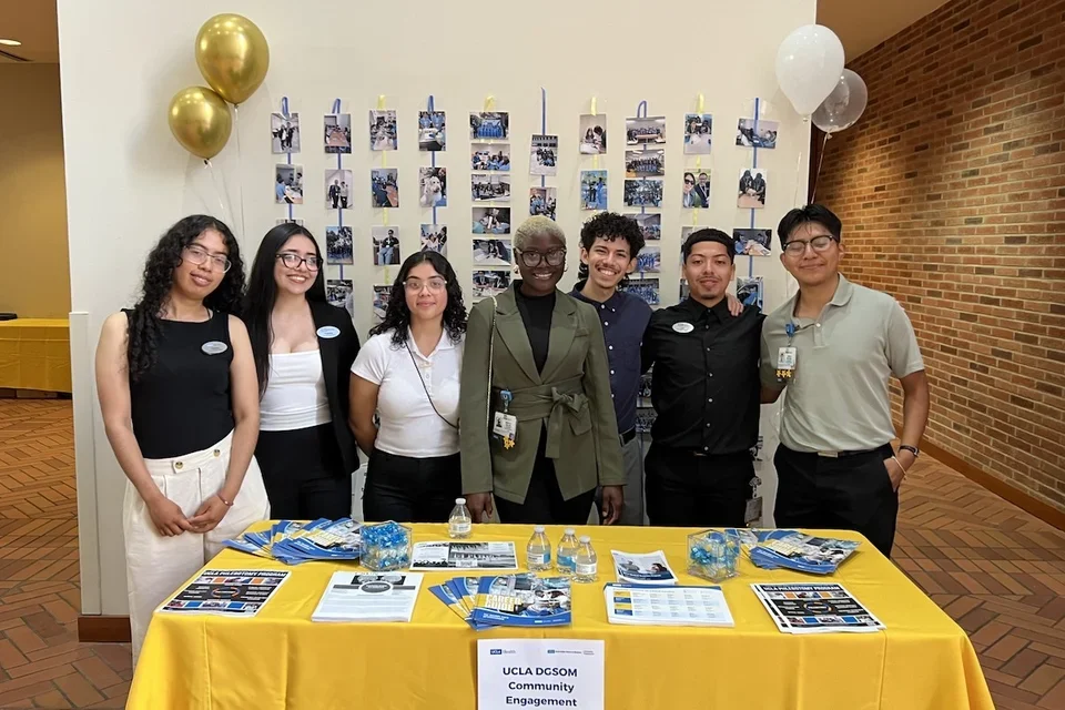 DGSOM students and alumni prepare to engage with community members at an event